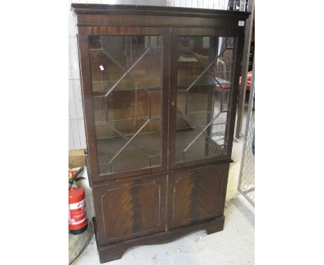 Mahogany, astragal glazed, two door display cabinet on bracket feet.