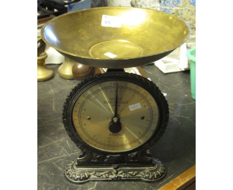 A Salter cast metal family scale number 45 with circular brass pan.