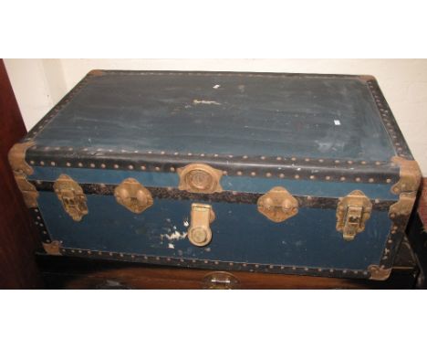 Vintage canvas trunk with metal mounts and brass stud work.