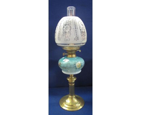 Brass double burner oil lamp with brass reservoir and brass pedestal base, etched glass shade and clear chimney. 