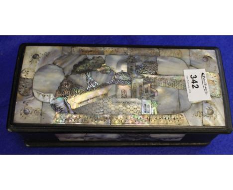Oriental narrow mother-of-pearl inlaid box and cover depicting house amongst trees.