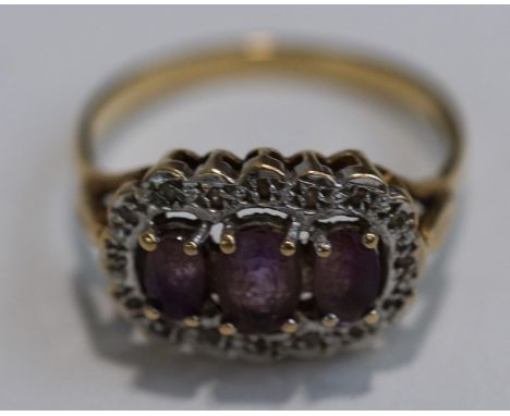 A 9 carat gold amethyst and illusion set single cut diamond cluster ring, finger size P, 2.8 g gross