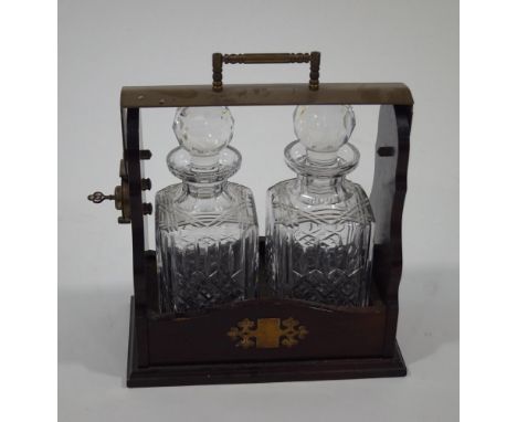 A 20th Century,mahogany two decanter tantalus, with brass mounts and key