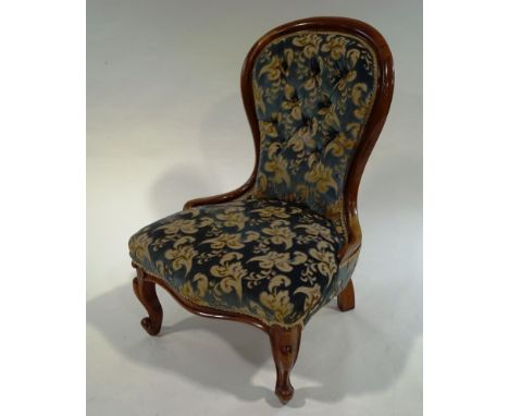 A Victorian mahogany spoon back salon chair, with button back upholstery, scroll frame and legs
