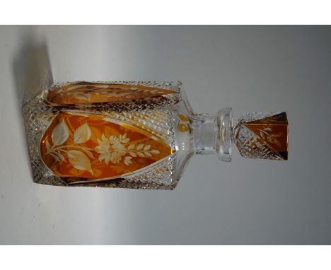 A Bohemian style cut glass decanter and stopper, arched amber coloured panels with flower designs, 27cm high