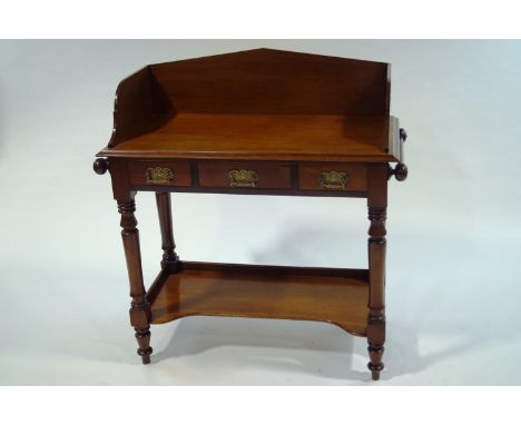 A Victorian mahogany wash stand, with side hanging rails and under tier shelf, 98cm high x 96cm wide x 48cm deep