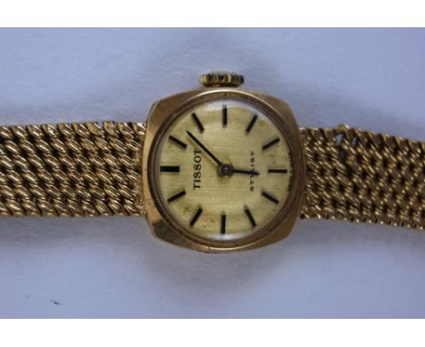 Tissot, a lady's 9 carat gold bracelet watch, the circular gilt dial with black batons and hands, with an integral Milanese b