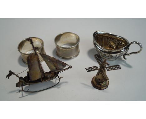 A late Victorian small silver cream jug; with a pair of Edwardian silver engine turned napkin rings; 68 g (2.1 troy ozs) gros