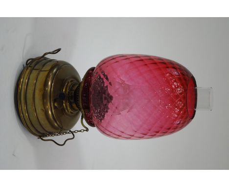A Victorian Veritas oil lamp, with brass burner and cranberry glass shade, 47cm high