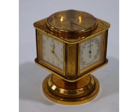 An Angelus combination desk clock, barometer, hygrometer, thermometer, and compass, 3.5cm square silvered dials, 8.5cm high