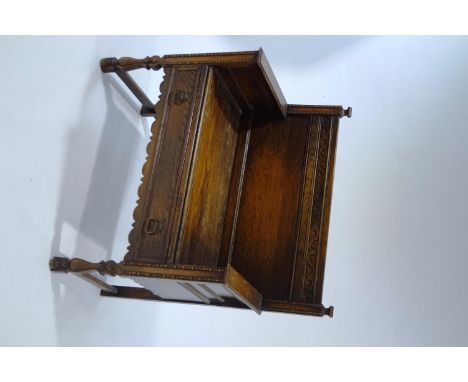 An early 20th Century oak hall bench, with drawer to seat, carved scroll detail, beaded and turned mouldings, 94cm high x 91c