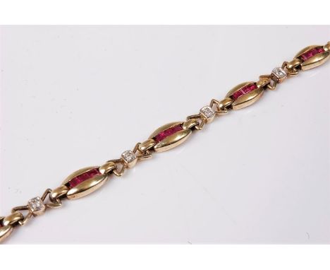 A ruby and diamond bracelet, the oval shaped links set with a central channel of three calibre cut rubies, each link interspa