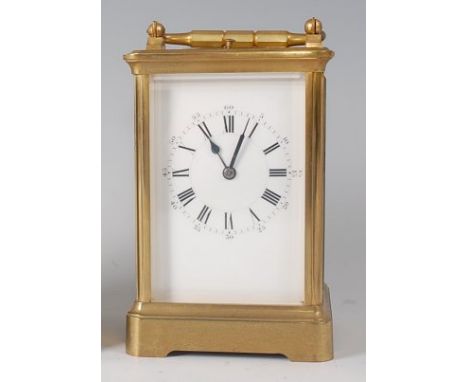 Henri Jacot of Paris - a brass carriage clock, having swing carry handle, visible platform escapement over white enamel dial,