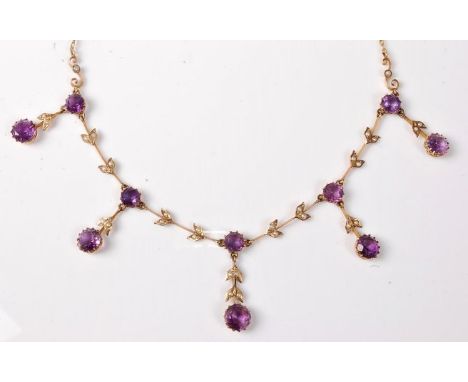 A late 19th century amethyst and seed pearl necklace , the five round amethysts each supspending an amethyst drop set with sm