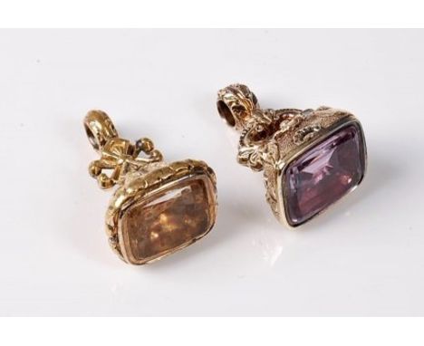 Two 19th century gemset fobs, the first rectangular fob with rounded corners, repousse moulding, set with a foil backed citri