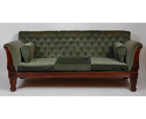 A Victorian rosewood showframe and green dralon buttonback upholstered three-seater sofa, on tulip carved forelegs and fluted