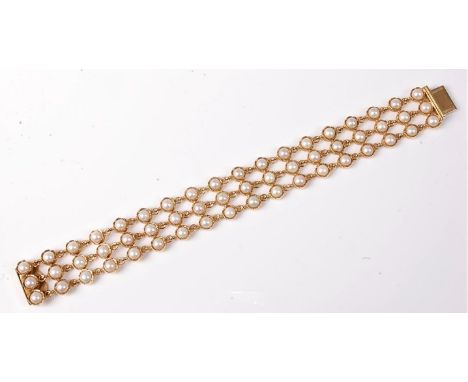 A 9ct gold cultured pearl bracelet, the three rows of cultured split pearls in collet mounts and joined by individual links, 