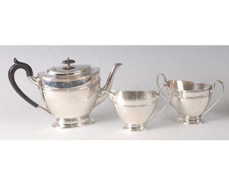 An Edwardian silver three-piece bachelors tea set, comprising teapot, twin handled sugar and cream, each of tapering oval for