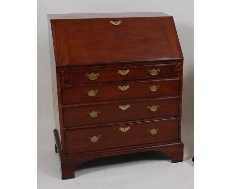 A George III mahogany bureau, the hinged fall revealing a fitted interior above four long graduated drawers, each with brass 