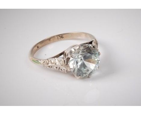A 9ct pale 'ice blue' zircon ring, the round zircon, approx. 8.1mm diameter, claw mounted to tapered engraved and milligrain 
