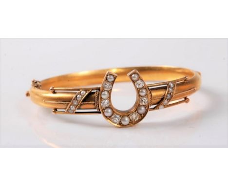 A diamond and pearl horseshoe bangle, the horseshoe set with six old European cut diamonds and slightly graduated alternating