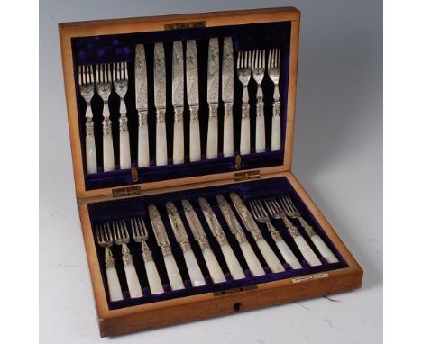 A cased set of twelve Edwardian silver dessert knives and forks by Elkington & Co, each having engraved blades, embossed coll