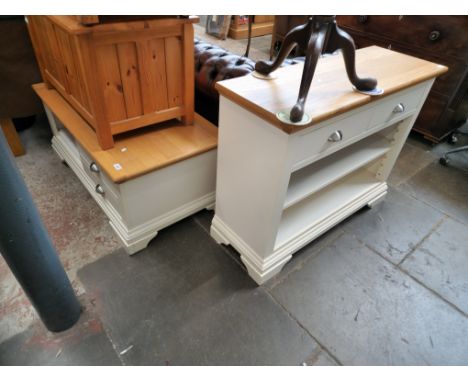 A modern light oak and painted bookcase and matching TV stand. 