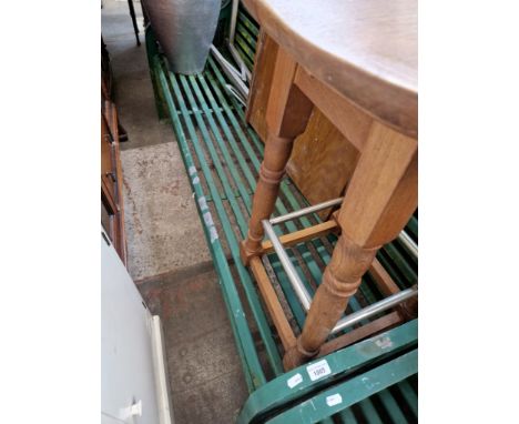 A green metal garden bench. 