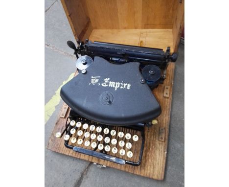 A vintage Empire typewriter in a wooden case 