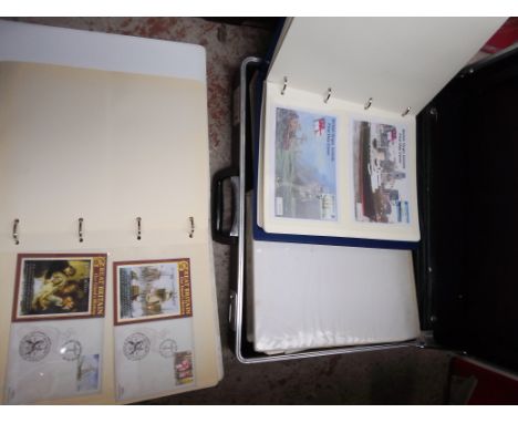 A case of assorted commemorative first day covers in albums 