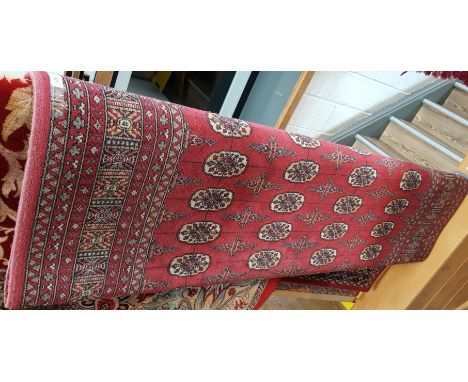 An Eastern style Bokhara pattern wool carpet by Ferdous, red ground, 170cm x 240cm. 