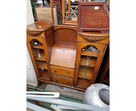 An Art Deco oak bureau display cabinet with leaded glass panels to the doors. 