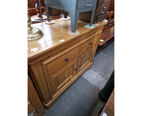 A modern light oak sideboard. 