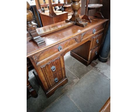 An oak pedestal desk and an oak and leaded glass bookcase. 