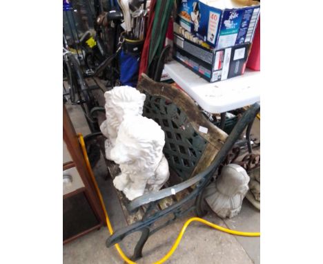 A cast metal bench and two concrete lions.