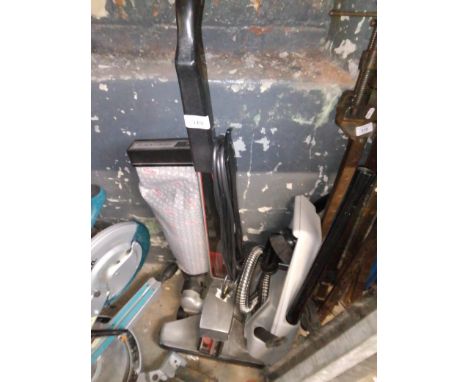 A Kirby vacuum cleaner with tools 