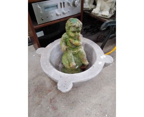 A circular concrete planter and a garden cherub figure - as found 