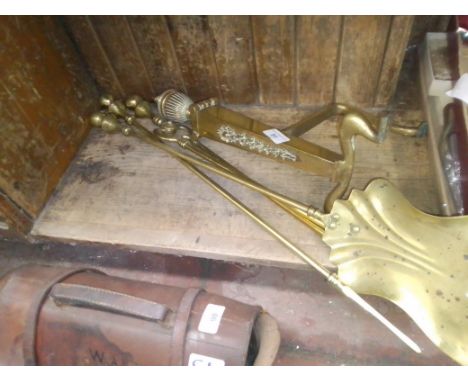 Brass fireside tools and dog. 