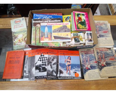 A mixed box including tea cards, children's books including Thomas the Tank Engine, vintage hiking maps 