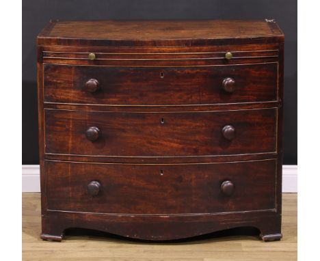 A George III mahogany bowfront bachelor’s chest, caddy top above a slide and three long graduated cockbeaded drawers, turned 