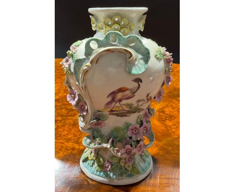 A Derby Patch Mark Rococo style pedestal vase, painted in polychrome with fanciful birds, encrusted with colourful flowers an