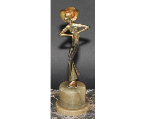 An Art Deco gilt and silvered figure, a lady of fashion, onyx plinth, 20.5cm high, c.1940 