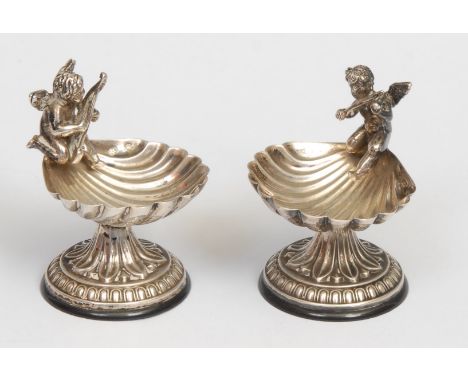 A pair of early 20th century Continental silver coloured metal salts, each as a shell surmounted by a putto playing music, 5.
