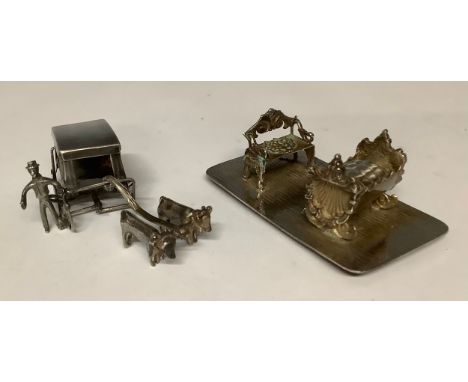 Boxes &amp; Objects - an ornate steel Art Nouveau miniature sofa and crib; a miniature ox-drawn sled and driver (2) 