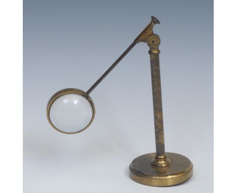 An early 20th century lacquered brass adjustable desk top magnifier, convex specimen lens, circular base, 18cm high 