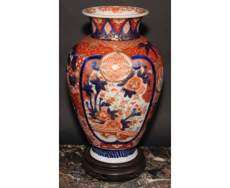 A Japanese ovoid vase, decorated in the Imari palette with birds, landscapes and floral motifs, picked out in gilt, carved ha