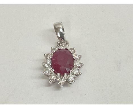 18ct white gold oval cut ruby and RBC diamond cluster pendant. Ruby 1.25ct. Diamonds 0.40ct