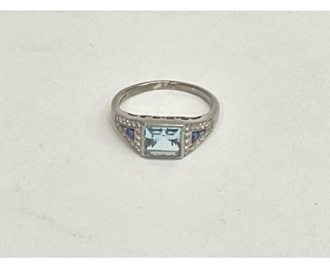 18ct white gold Art Deco style step-cut blue topaz, calibre cut sapphire and R/C diamond ring