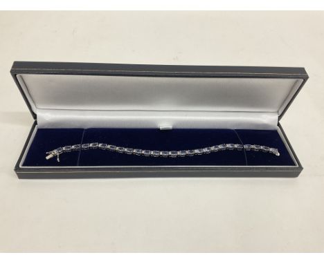 White gold alternate set oval tanzanite and R/C diamond line bracelet with open box clasp and double safety catch, boxed