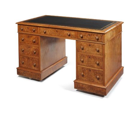 A Victorian burr walnut pedestal desk by T.H.Filmer & Sons The rectangular moulded top with later black leather and gilt writ